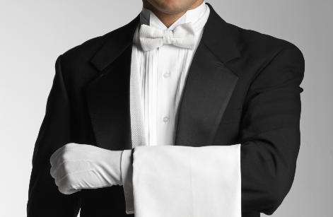 Gentleman sitting hunched over at a desk angrily tying at an old computer.