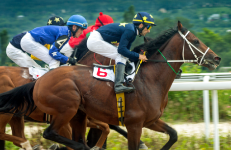 Gentleman sitting hunched over at a desk angrily tying at an old computer.